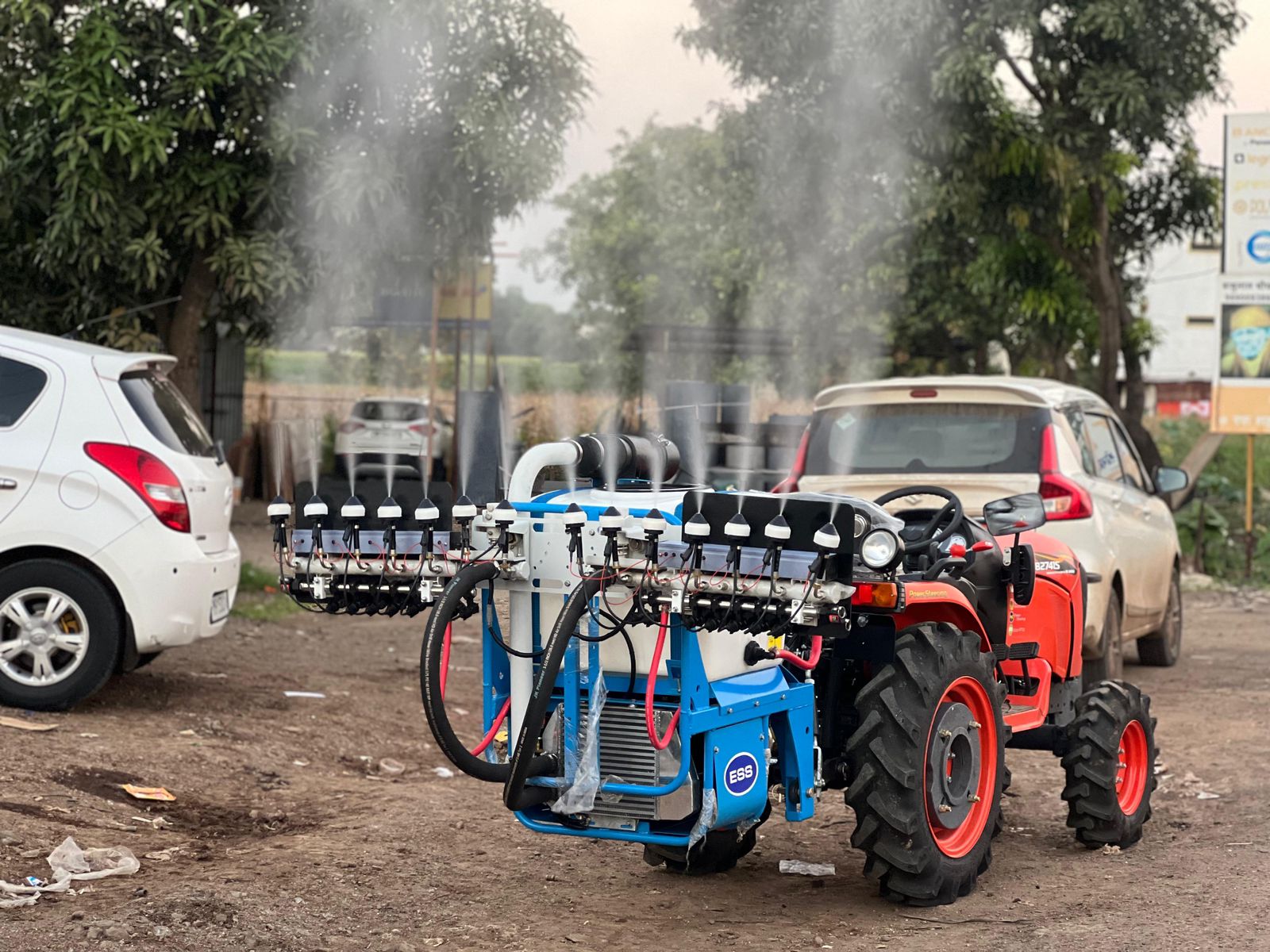 Sprayer mounted on tractor parked at yard