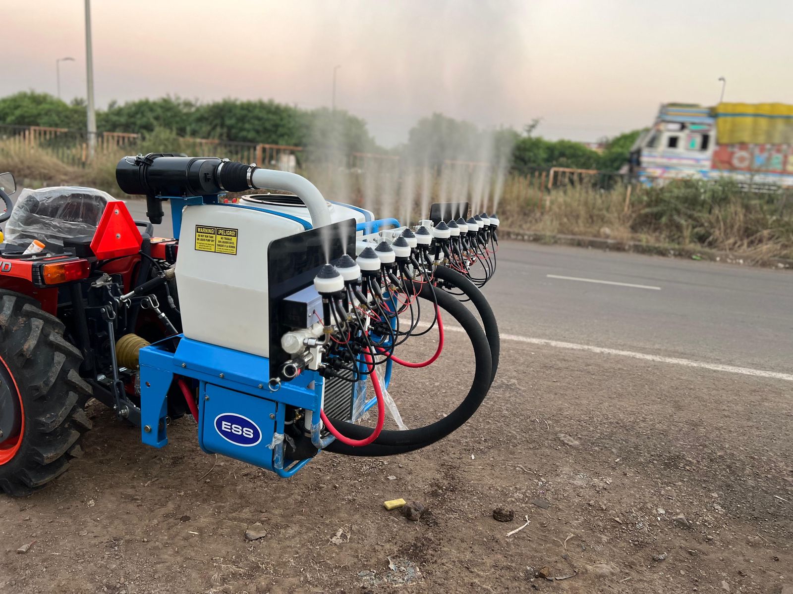 Side view of sprayer with mist rising